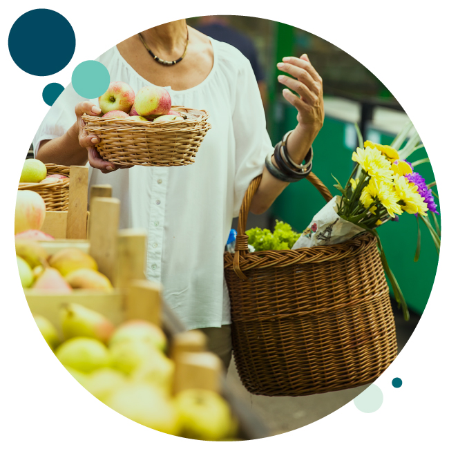Woman shopping at farmers market with her Checking Account